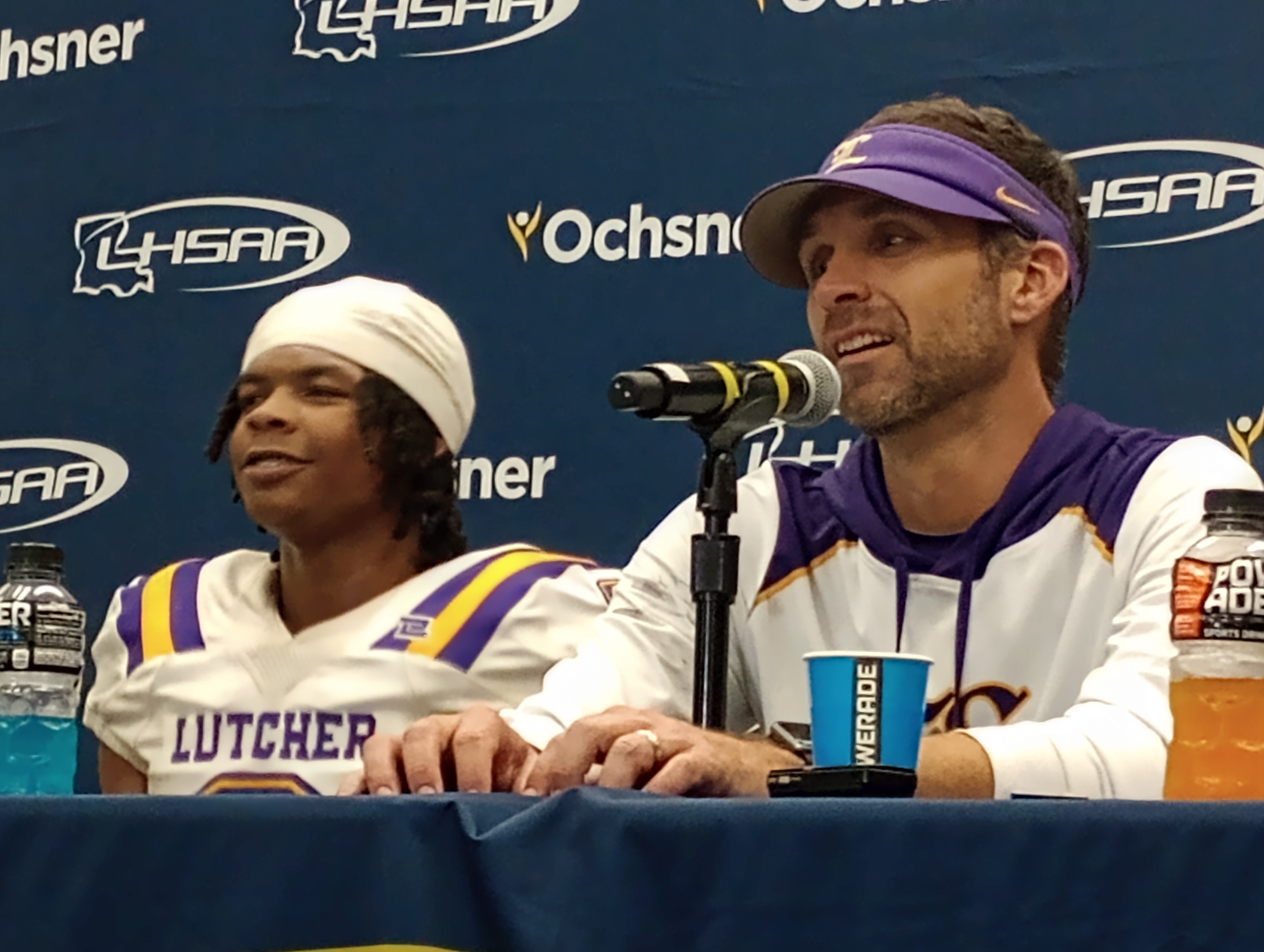 Lutcher CB Craydon Long, left, and coach Dwain Jenkins discuss the Bulldogs' 28-25 win against North DeSoto for the Division II non-select championship on Dec. 10, 2022.